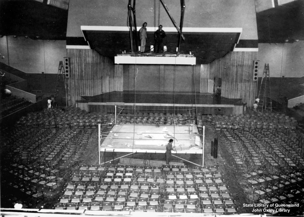 Festival Hall, Brisbane.
Interior view of Festival Hall being readied for a boxing? tournament.
Festival Hall was built by the Queensland Government in Brisbane in 1959. It was big enough to host ballets, boxing matches, rock concerts, and even roller-derbies. It attracted touring acts from Australia and abroad who would have otherwise have not visitied Brisbane. It was demolished in 2003.
