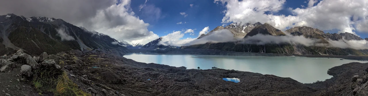 Aerial view of the upper half of the Tasman Glacier, in New Zealand's Aoraki/Mount Cook National Park. The plane's wing is visible in the upper right corner.