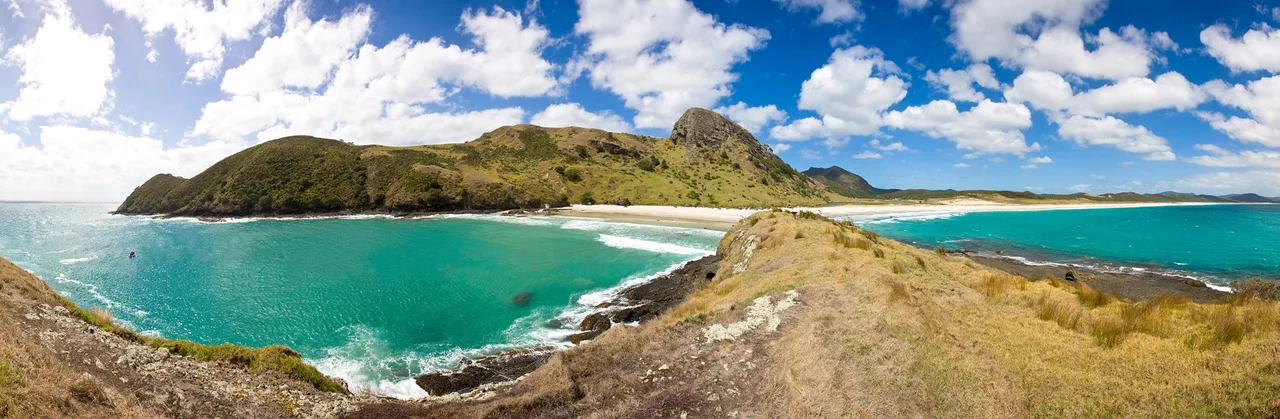 View of Spirits Bay (right) from the eastern end, showing the stretching golden 12km long beach, and Te Karaka Bay (left).