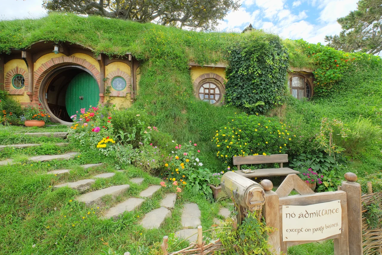 Fully restored Baggins residence 'Bag End' with 'no admittance except on party business'-sign; all parts of the Hobbiton location are maintained to movie set standards, supported by guided tours