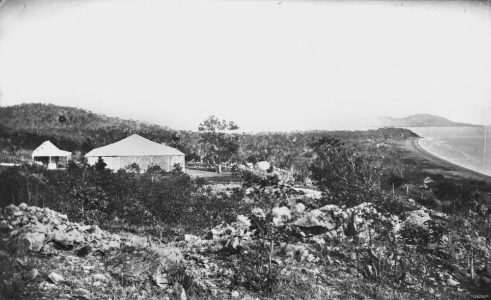 John Melton Black's residence, the first home in Townsville built around 1865
View Melton Hill in Townsville, looking north. The residence belonged to John Melton Black and was constructed around 1865, the first house in Townsville. The small structure to the rear is Black's observatory. The range in the far distance in the extreme right is Cape Pallarenda, the beach on the right is The Strand and the suburb of North Ward. The small hill at the end of the beach being Kissing Point.
Richard Daintree, geologist and photographer, was born in 1832 in Huntingdonshire, England. He matriculated at Christ's College, Cambridge in 1851 and in 1852 joined the gold rush to Victoria. Unsuccessful as a prospector he became assistant geologist in the Victorian Geological Survey until 1856. On a visit to England he became interested in photography and when he rejoined the Geological Survey in 1859 he pioneered the use of photography in field-work. In 1864 he became a resident partner with William Hann in pastoral properties in the Burdekin country of North Queensland. There he was able to indulge his passions for both photography and prospecting. When the pastoral boom collapsed he used his knowledge to open up goldfields at Cape River (1867), Gilbert (1869) and Etheridge in 1869-70.

Daintree advocated a geological survey of Queensland and when it began in 1868 he was geologist in charge of the northern division until 1870. In that year he made some of his finest photographic studies. In 1871 his collection of photographs and geological specimens formed the mainstray of Queensland's contribution to the Exhibition of Art and Industry in London. He was sent to England as commissioner in charge of this display, although much of it was lost when the ship carrying Daintree and his family was wrecked. In London he was appointed Queensland's agent-general in 1872. Due to ill health Daintree resigned in 1876 and died in Kent on the 20th June, 1878. His photographs , taken under difficult conditions by the cumbersome wet-plate process, are superb specimens of the art and present a vivid picture of early settlement in Queensland.