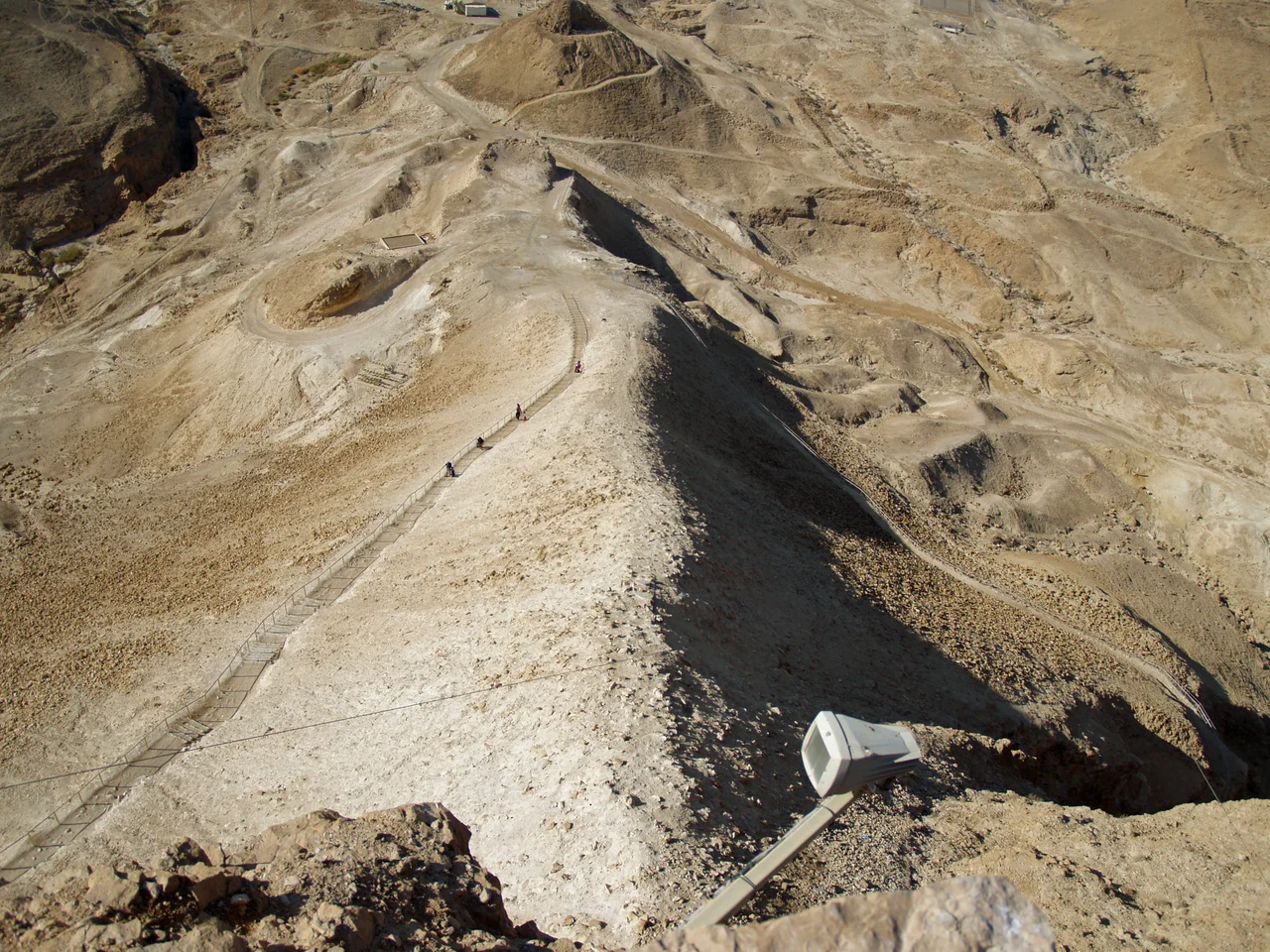 Aerial view of Masada (Hebrew מצדה), in the Judaean Desert (Hebrew: מִדְבַּר יְהוּדָה‎, Arabic: صحراء يهودا), with the Dead Sea in the distance.
