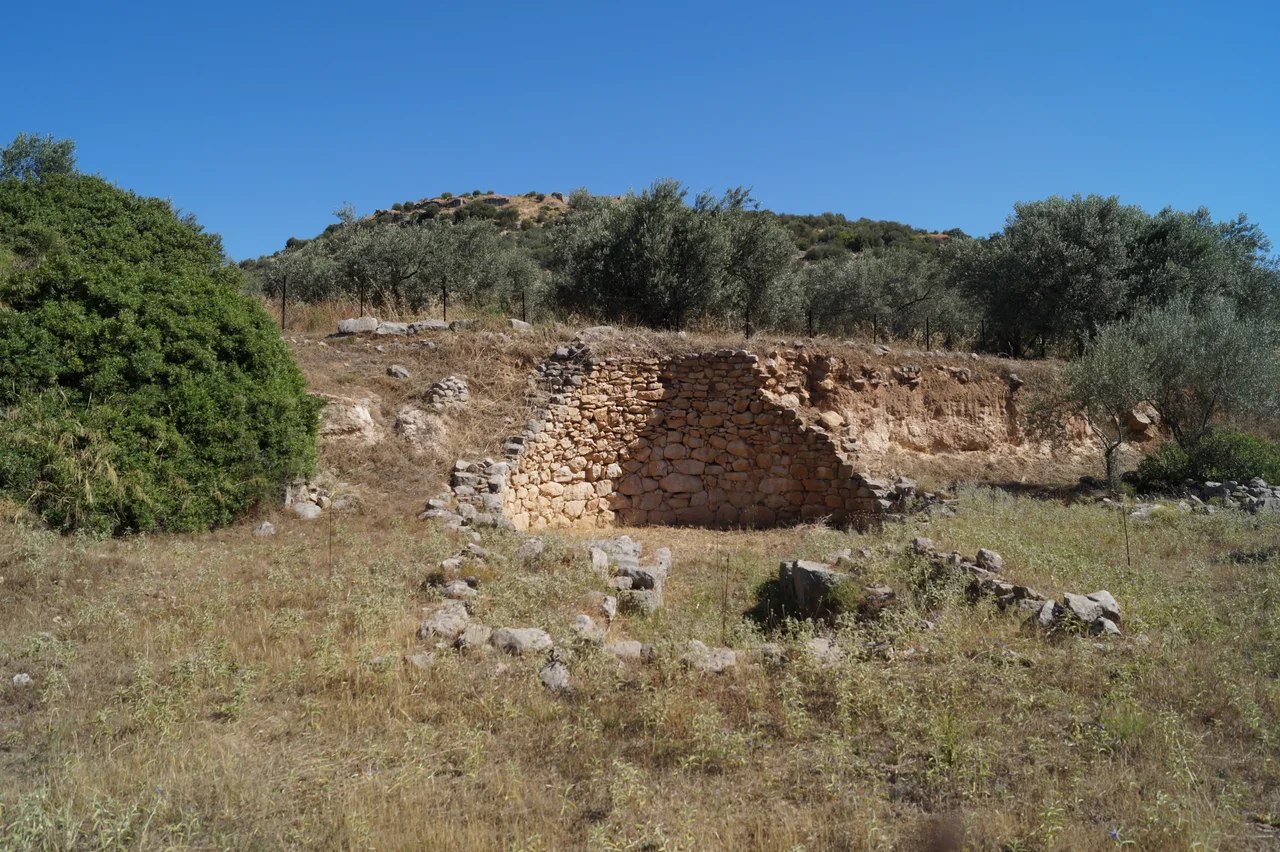 Arkadiko, Argolis, Greece: Kazarma Tholos Tomb. In the background there is the acropolis of Kazarma.