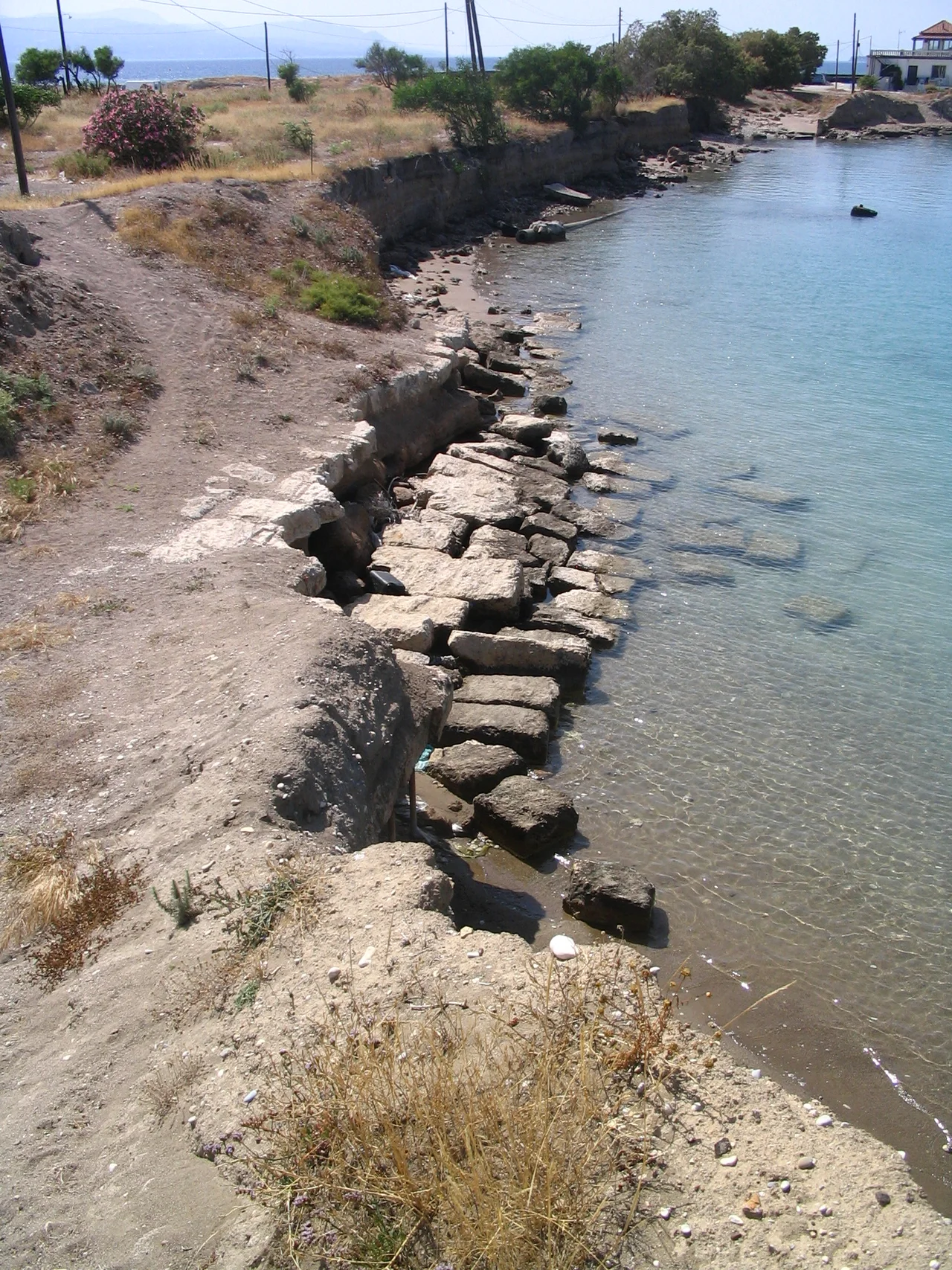 Western end of the ancient Greek ship trackway Diolkos across the Isthmus of Corinth in Greece. Bank erosion of the adjacent Canal of Corinth has damaged the ancient ashlar paving.