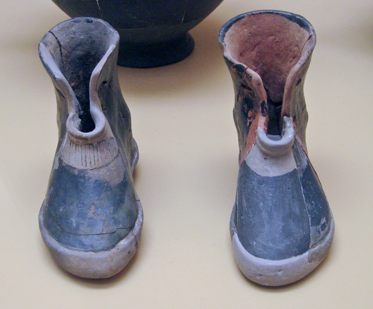 Ancient Greek pair of terracotta boots. Early geometric period cremation burial of a woman, 900 BC. Ancient Agora Museum in Athens.