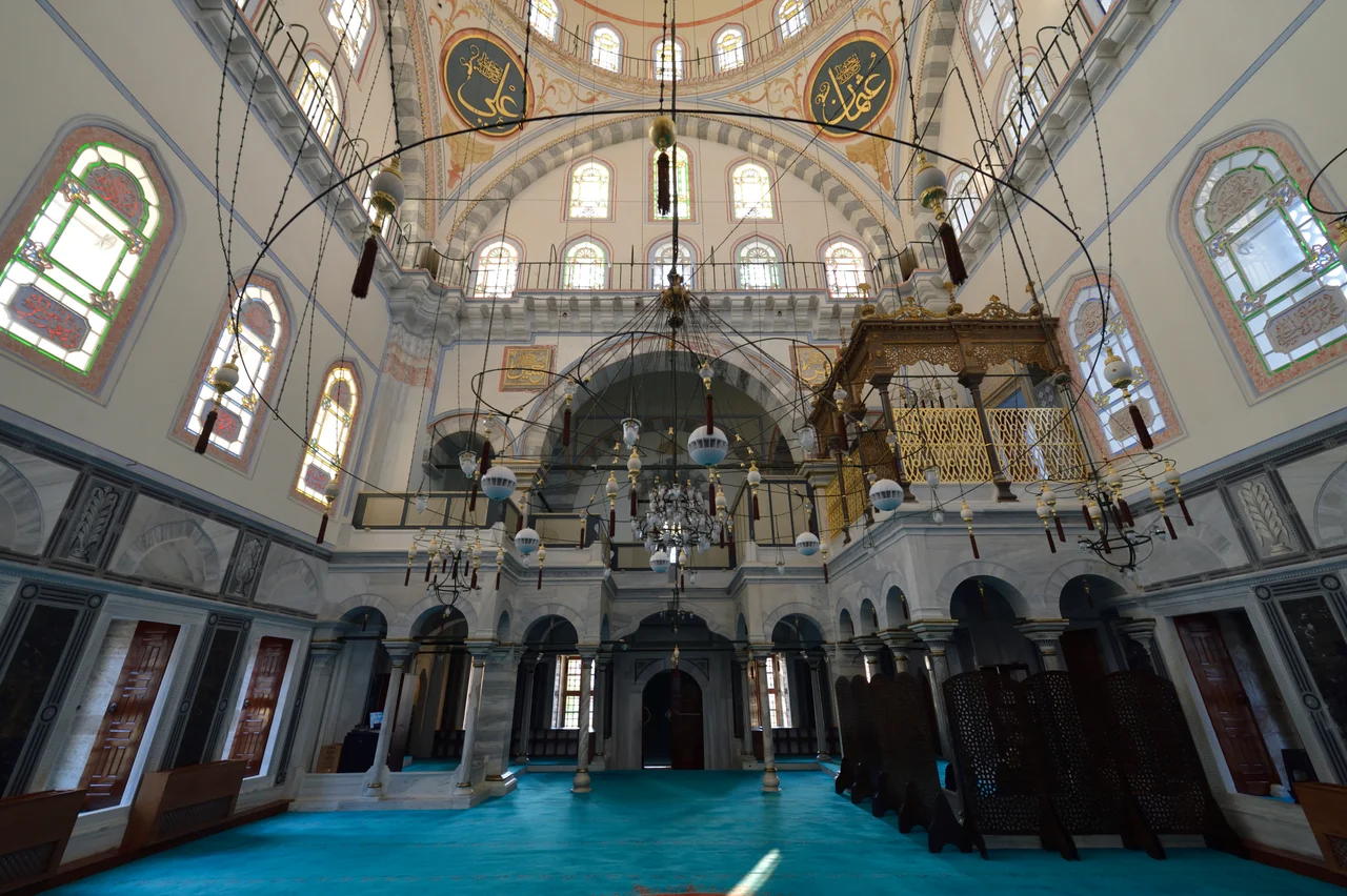 One of pictures of the interior of the mosque. After entering from the northwest there is first a royal loge (hünkâr mahfili) to the left. Farther along the wall there is a kursu, a chair for the imam when addressing the congregation but not from the more formal mimber, the structure with a flight of stairs to the right of the mihrab, which is the prayer niche where the imam will be when praying.