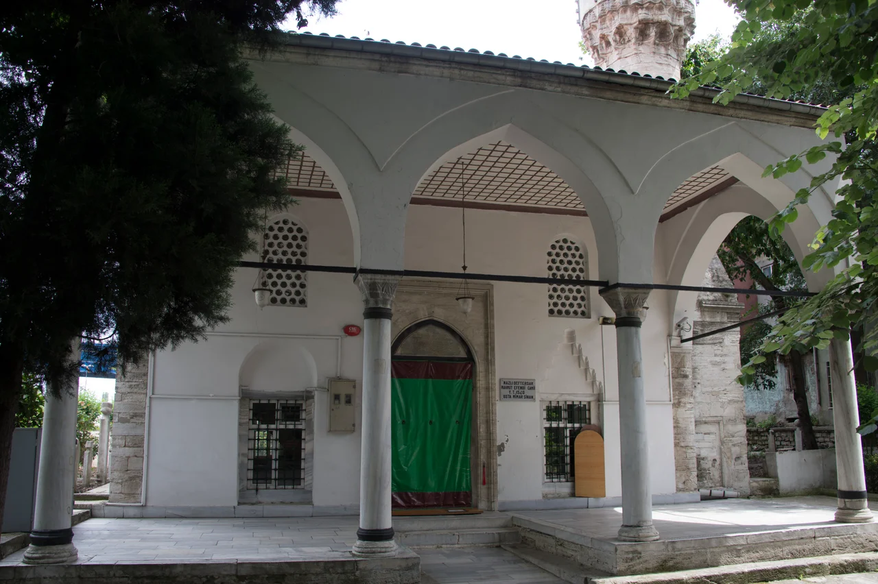 The Defterdar Mahmut Efendi mosque (Defterdar = Lord high treasurer) is ancient in foundation (it seems to be by Sinan), but it was wholly rebuilt in the 18th century. Strolling through Istanbul calls it “of little interest in itself” and I agree (though the setting is nice, in a small garden off a very busy road where traffic speeds along if is not stuck. In the garden is the founder’s open türbe, with a dome supported on arches with scalloped soffits