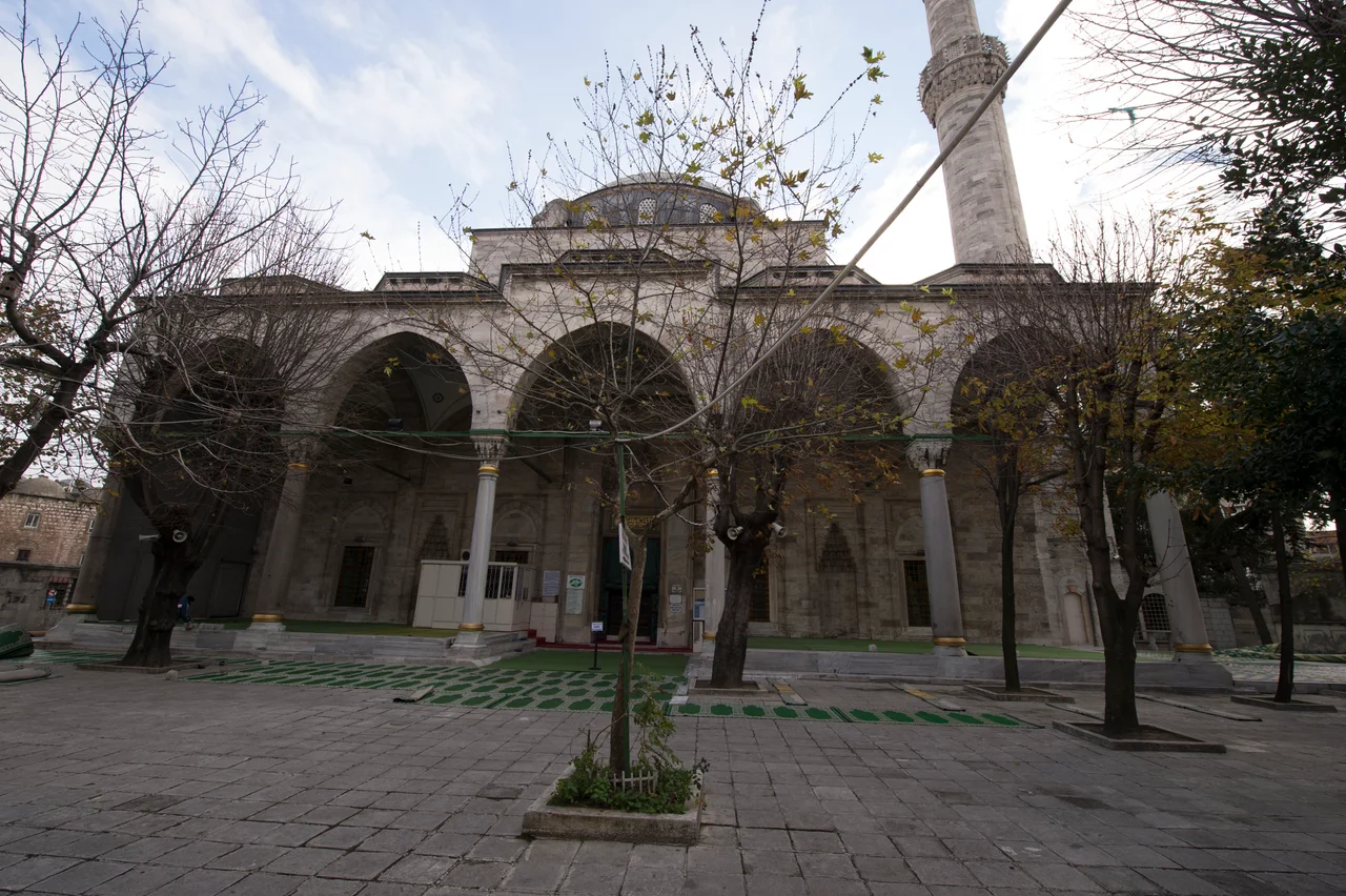 The mosque is one of the oldest in town, being built in 1496 by the Hadım (Eunuch) Atik Ali Paşa who was a Grand Vezir of Sultan Beyazit II. The complex has been larger, but was partly destroyed when the main road nearby was constructed. However, the mosque still sits in a quiet courtyard. It differs from similar mosques in that the central rectangular space consists of a large room covered with a dome, and a continuation where, in the East, the mihrab is situated. The first space has to either side two rooms with smaller domes. The stalactite pendentives are well proportioned and fine.