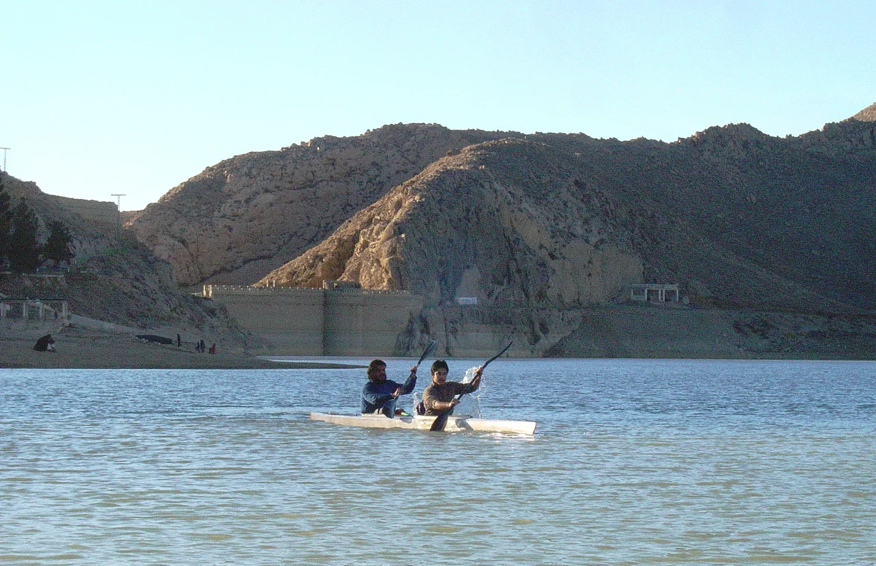 Ali Khilji and Abubakar Durrani Kayaking in front of Hanna Lake Bridge Wall constructed by Great Britain in 1894.
