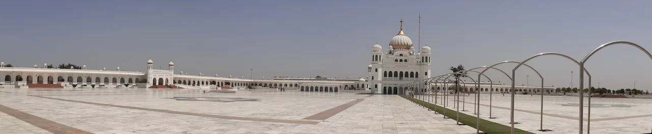 Gurdwara Sri Darbar Sahib or Gurdwara Darbar Sahib Kartarpur, also called Kartarpur Sahib, is a Gurdwara in Kartarpur, located in Shakargarh, Narowal, Punjab, Pakistan.
Quote by Guru Nanak: "Speak only that which will bring you honor".
The Kartarpur Corridor is known as the corridor of ‘international peace &amp; harmony’ is a 4.2-km-long passage connecting the town of Dera Baba Nanak in India with the Kartarpur Sahib Gurdwara in Pakistan.
Facts 
1. Opened by PM. Imran Khan on 09 Nov 2019, just days before the 550th birth anniversary of Guru Nanak. This historic moment officially allowed Indian Sikh pilgrims rare visa-free access to the site.
2. The Congregation is notable for its location. The Shrine is visible from the Indian border. Indian Sikhs gather in large numbers to perform darshan (sacred viewing) of the site.
3. It is also claimed to be the largest Gurdwara in the world &amp; the second holiest site of the Sikh Religion. Guru Nanak (founder of Sikhism, &amp; the first Guru) built town by Ravi River in 1515, plowing the fields &amp; setting up a Sikh community kitchen, or Langar, after his missionary travels &amp; lived for 18 years until his death on 22 September 1539. The Gurdwara is built where Guru Nanak is said to have died.
4. He gave the three principles of Kirat Karo, Naam Japo, Wand Chako, which means work hard for a livelihood, keep remembering the God &amp; share your bounties with the world. Guru's teachings have been peace, harmony &amp; universal brotherhood. He believed in equality between castes, religions &amp; genders.

5. The main Building was built in 1925 at a cost of Rs.1,35,600/- donated by Sardar Bhupindar Singh, the Maharaja of Patiala. It was further expanded in Nov 2018 with the construction of a new courtyard, museum, library, dormitories &amp; locker rooms spread across an area of 42 acres (17 hectares). There is a 20-foot well, which is 500 years old &amp; believed to have been built during the lifetime of Guru Nanak Dev.