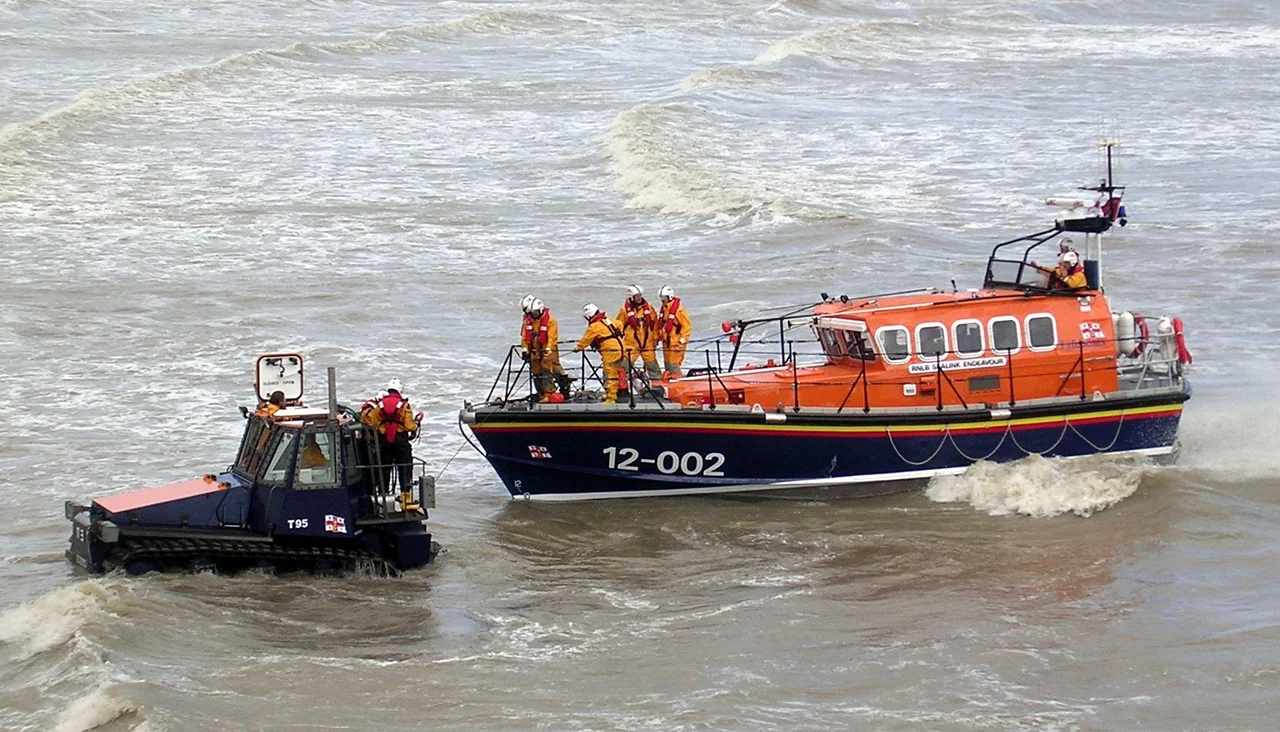 Hastings lifeboat meeting tractor at sea for recovery to beach