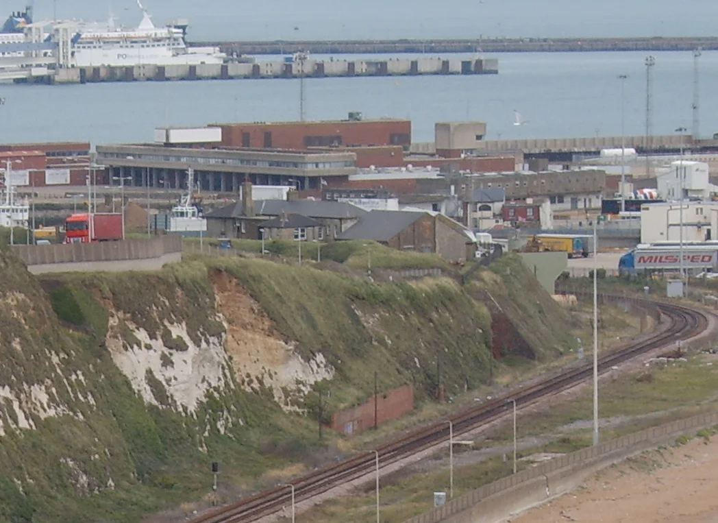 With the port of Dover in the background, Class 375 "Electrostar" EMUs operated by SouthEastern are seen approaching Shakespeare Tunnel on the line between Dover Priory and Folkestone. Photo was taken from the footpath which runs along the cliff tops. The path in fact is part of the North Downs Way which starts in Farnham in Surrey and finishes in Dover. Photo taken on 29 July 2008.