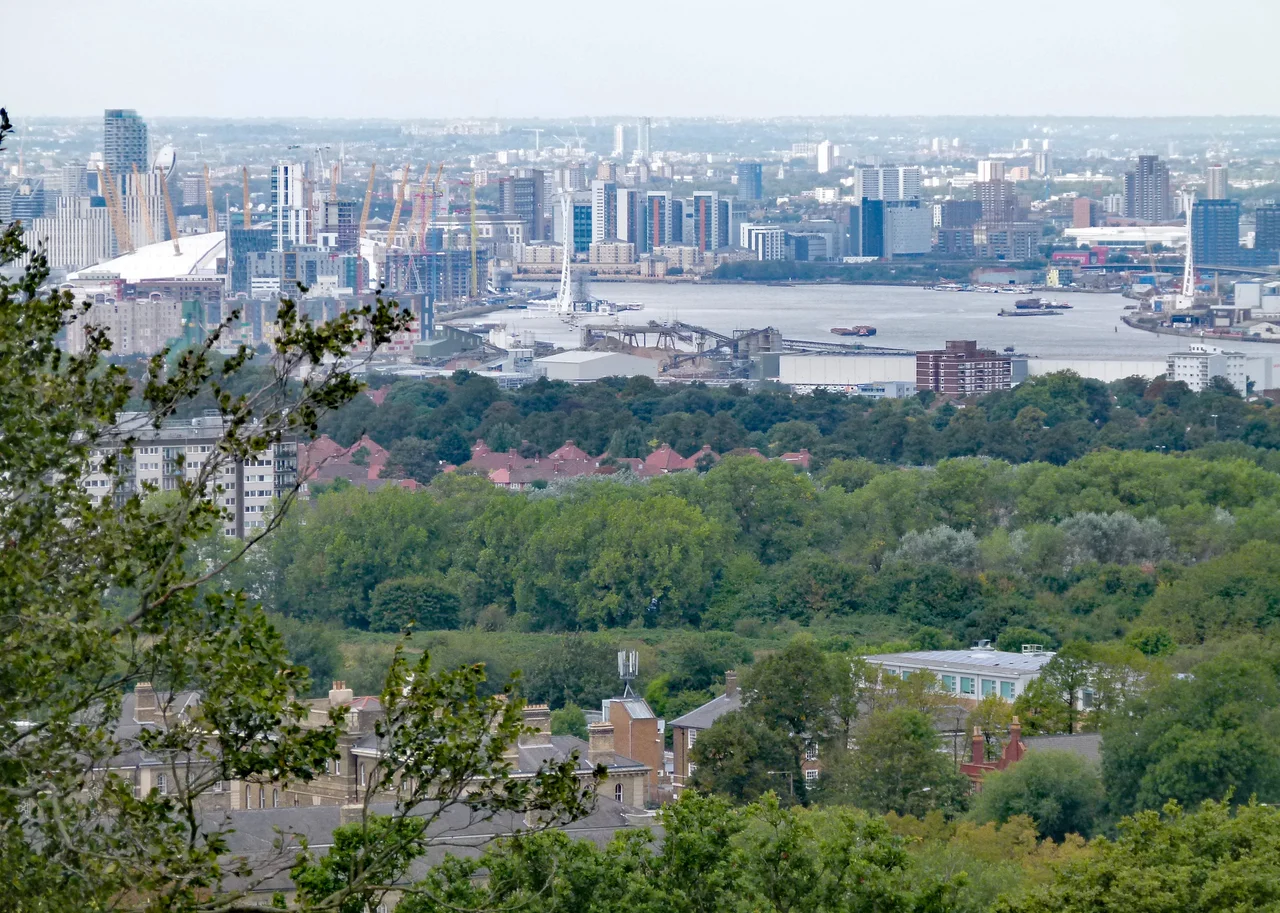 View towards the northwest from the top of Severndroog Castle, Shooters Hill, South east London, UK. Foreground left: Herbert Hospital. Centre: Woolwich Common, Charlton Riverside and river Thames. Background left: Greenwich Peninsula.