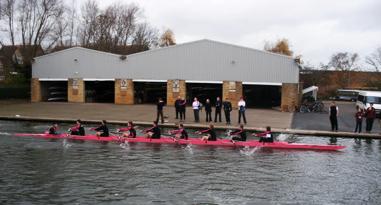 Churchill College first mens' boat passing their boathouse on the River Cam during the Fairbairns Cup, November 2007.