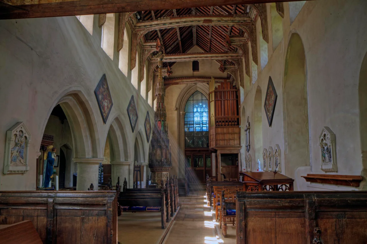 Inside the nave of the parish church of the Assumption of the Blesséd Virgin Mary, Ufford, Suffolk, looking west to the tower arch. Note the tall ornate cover on the font near the west end of the nave.
An HDR image taken with Canon 7D and Canon 17-55mm F2.8 IS lens. AEB +/-3 total of 7 exposures processed with Photomatix. Colors adjusted in PSE 9.