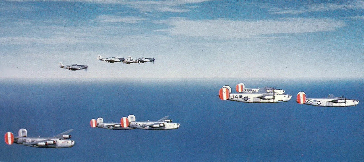 U.S. Army Air Force Consolidated B-24H Liberator bombers of the 458th Bombardment Group (Heavy), based at RAF Horsham St Faith, England, over the North Sea with a close escort of North American P-51B/D Mustangs of the 352nd Fighter Group in 1944/45. The B-24s visible were from the 753rd Bombardment Squadron (Heavy) (J4), and the 754th Bombardment Squadron (Heavy) (Z5).