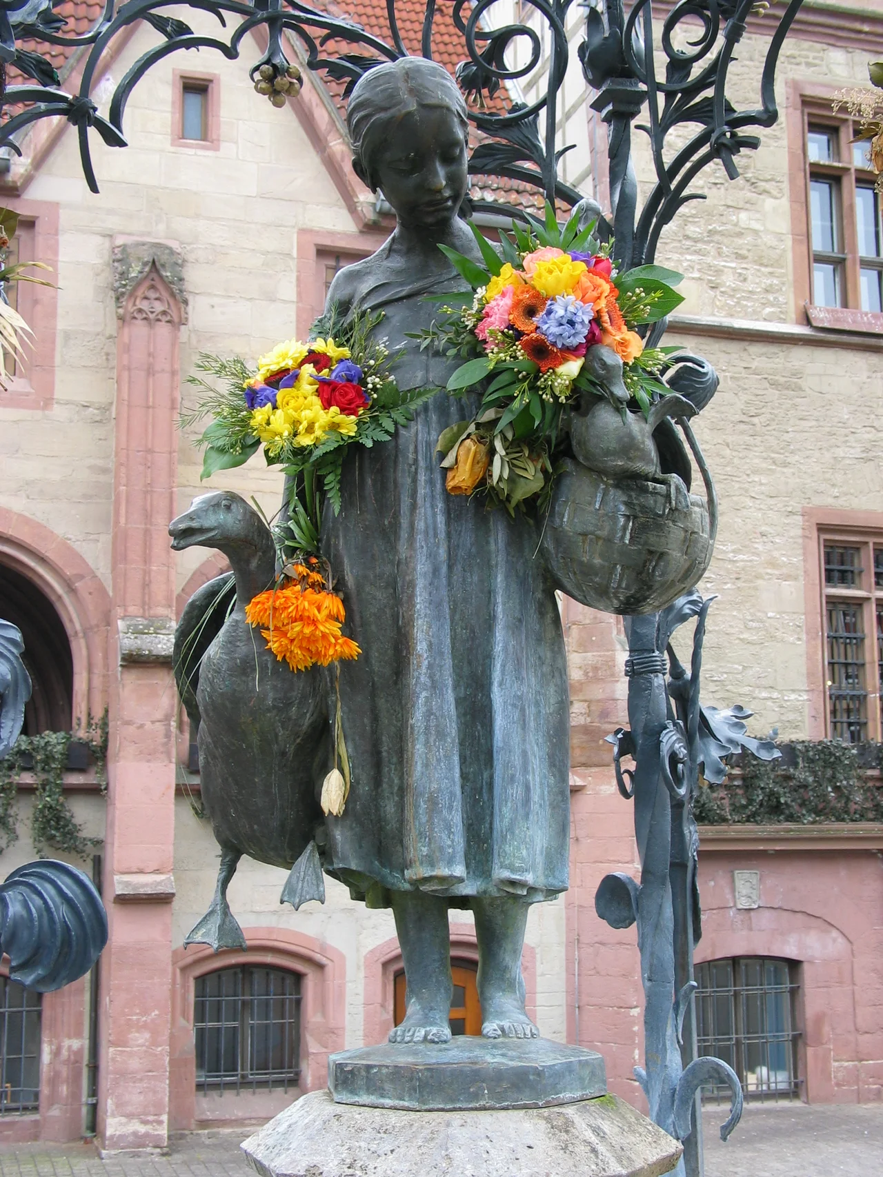 Gänseliesel fountain on the market square in Göttingen. Old townhall in the background.