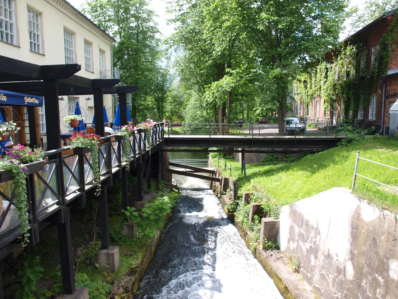 Central Fiskars, Finland in the summer. On the left side is a restaurant, on the right side is an artisan workshop.