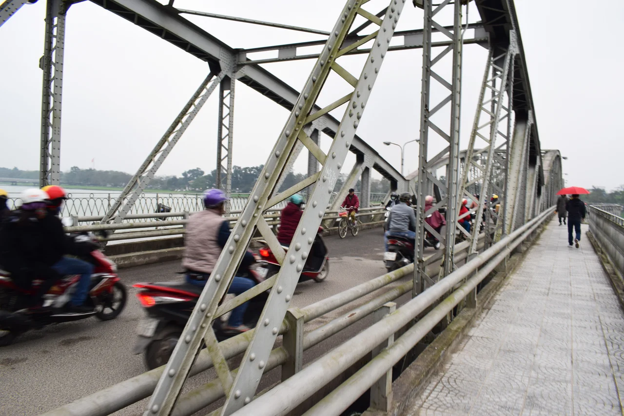 Motos wizzing over Truong Tien Bridge