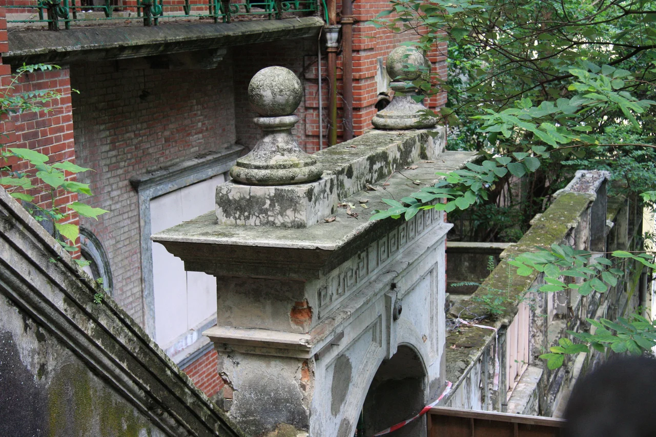 Nam Koo Terrace Architecture. Arch and outer property wall.