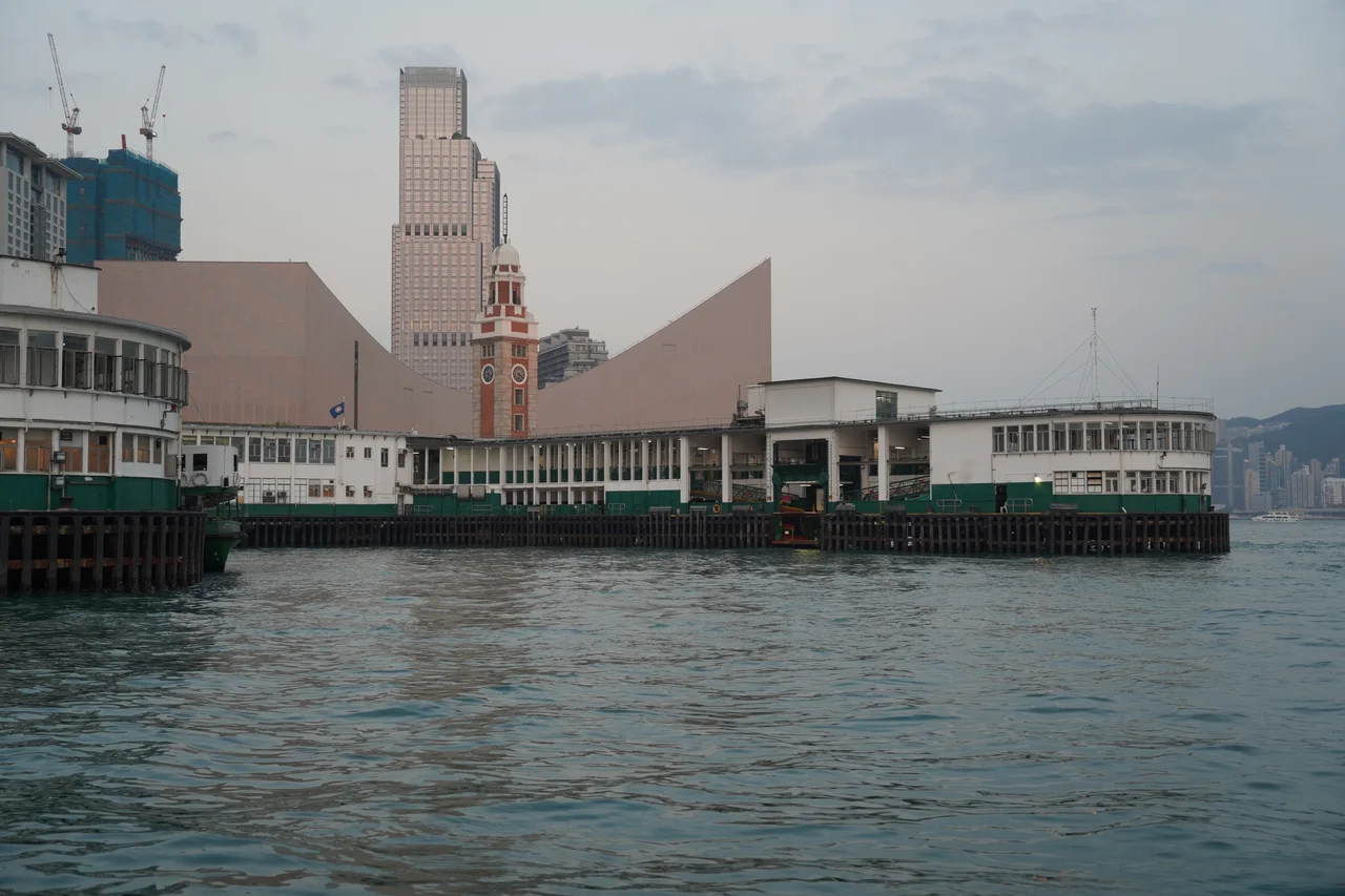 Tsim Sha Tsui Ferry Pier ("Star Ferry Pier") in Kowloon, Hong Kong. Across the bay is Wan Chai. An unidentified Star Ferry vessel at the pier.