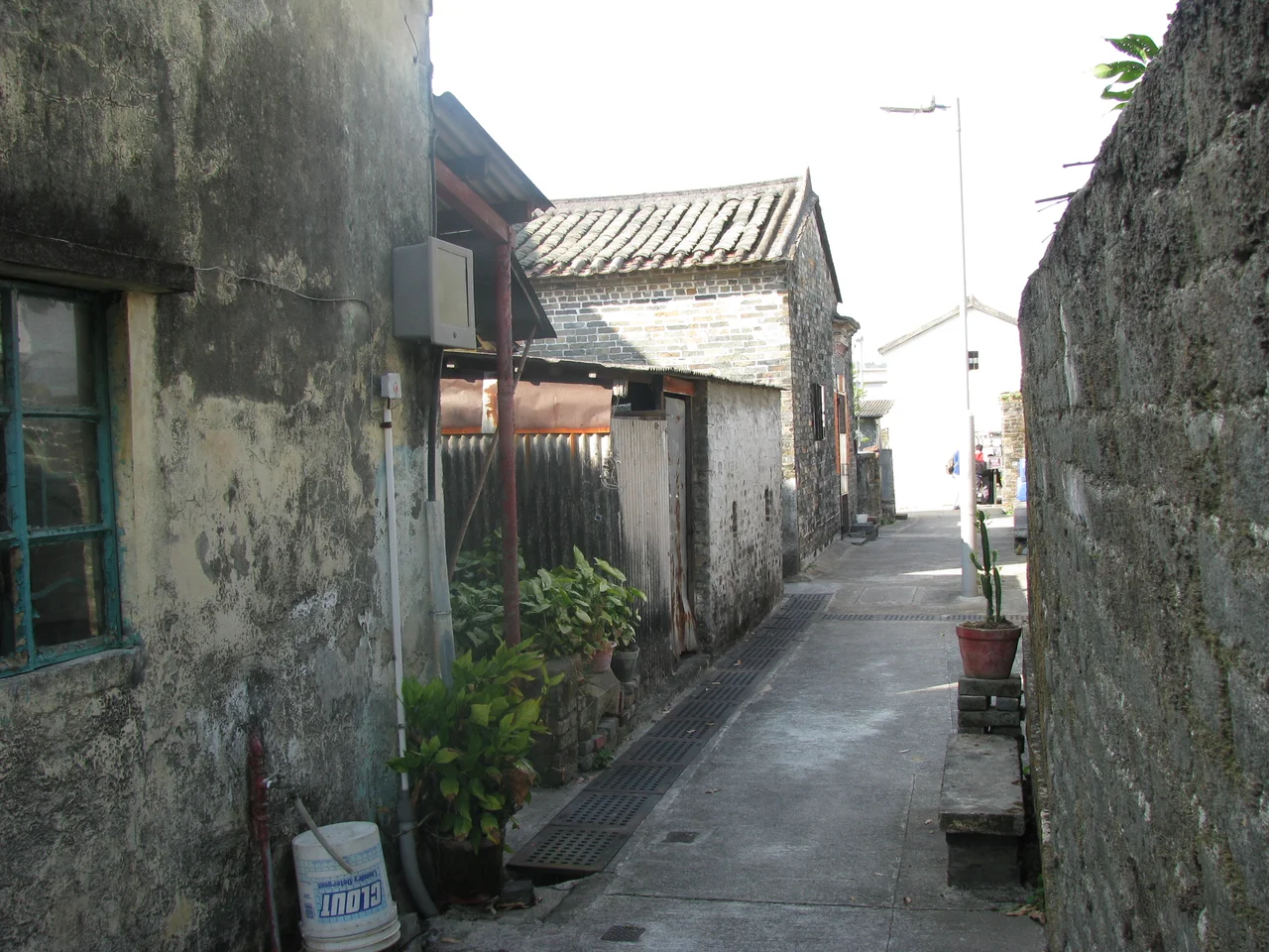 Inside Lo Wai walled village, in Lung Yeuk Tau, Fanling, Hong Kong. The white building in the background is the entrance tower of the village.