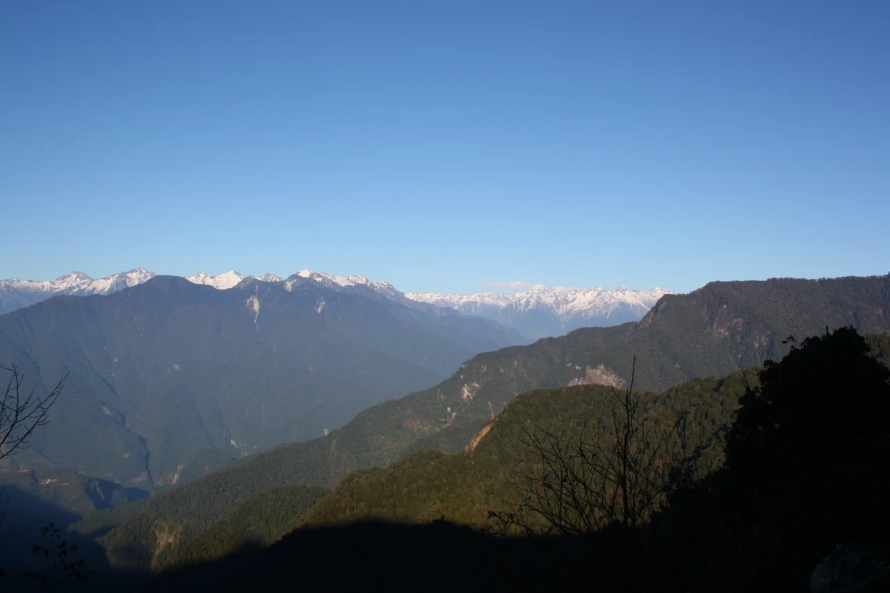 Snow capped Tops of Mishmi Hills, view from Mayodia Pass. Hunli Town at the bottom left