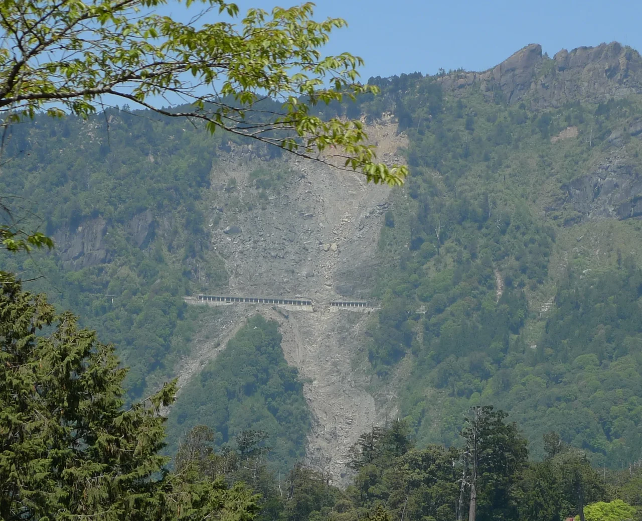 A damaged portion ( 23°31'55.80"N, 120°48'18.03"E ) of the Alishan Forest Railway destroyed by a landslide caused by Typhoon Morakot in August 2009. Image was taken from the Alishan National Scenic Area across the valley